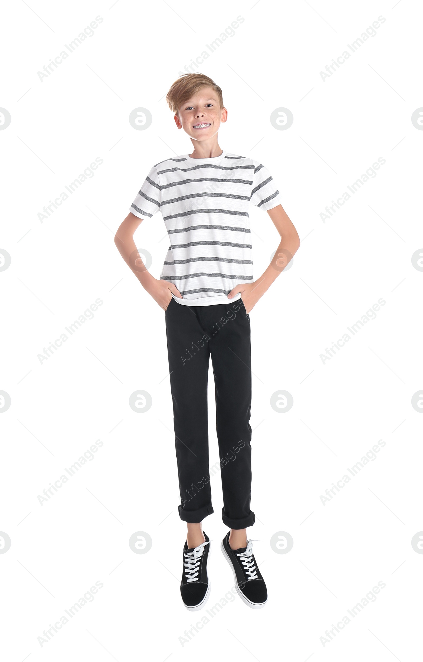 Photo of Portrait of young boy jumping on white background