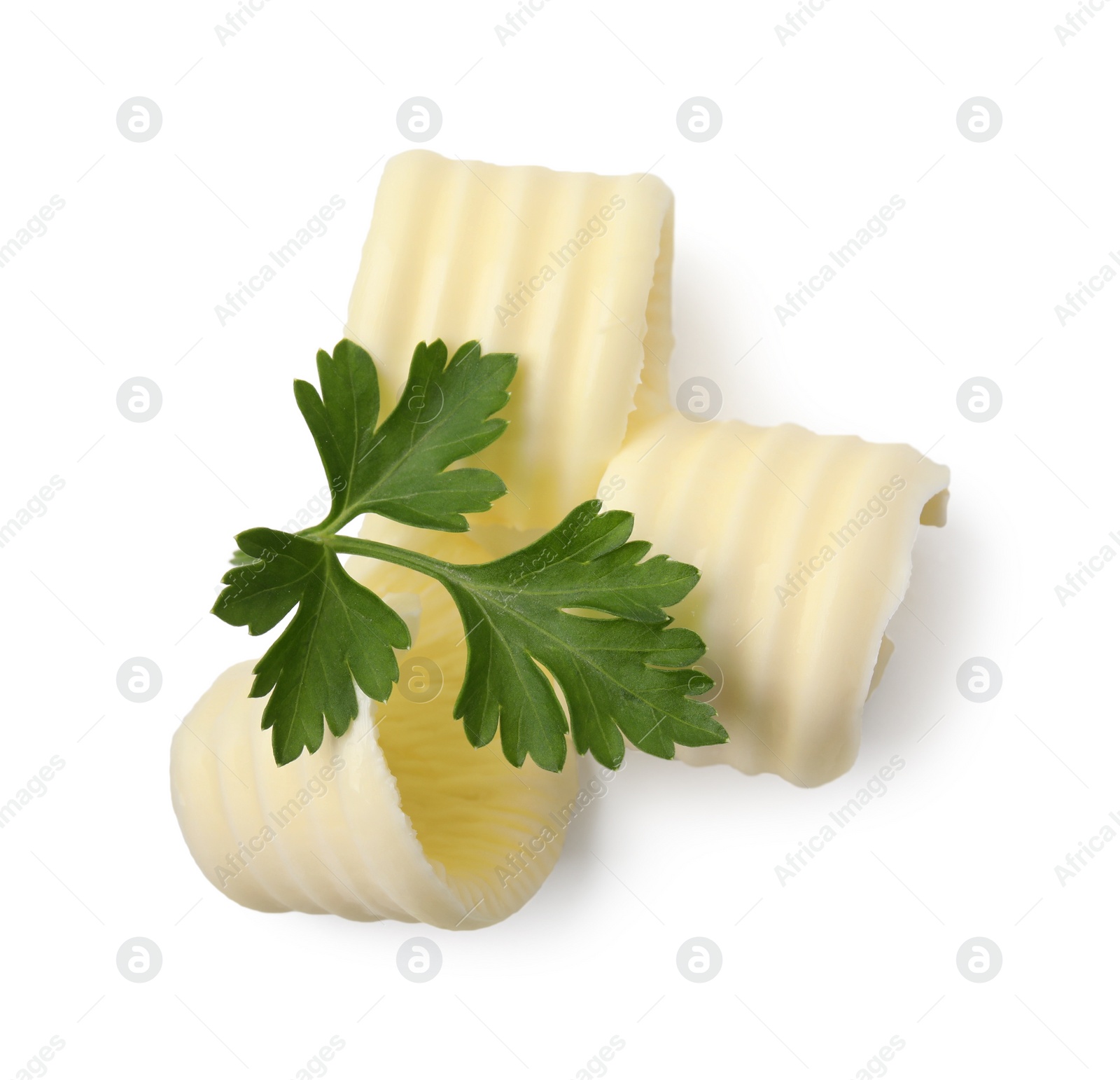 Photo of Tasty butter curls and fresh parsley isolated on white, top view