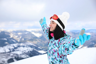 Young woman at mountain resort. Winter vacation
