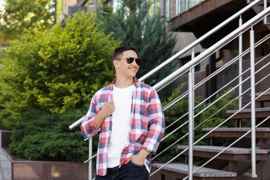 Young man in stylish outfit outdoors. T-shirt as mockup for design