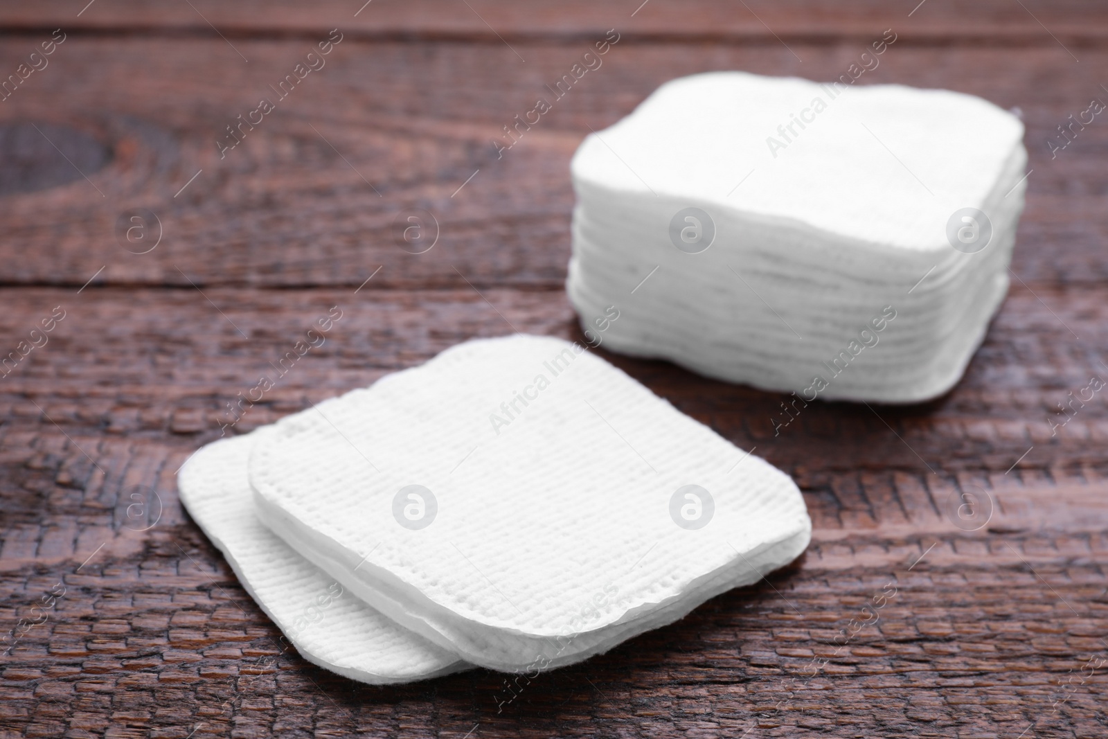 Photo of Clean cotton pads on wooden table, closeup