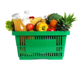 Shopping basket with grocery products on white background