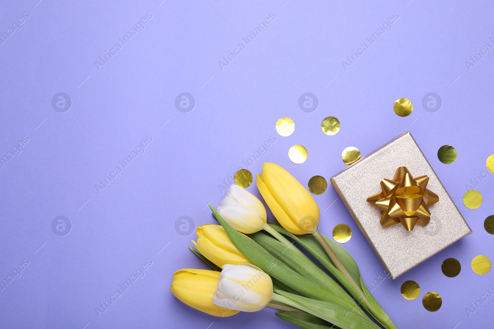 Photo of Bouquet of tulips, confetti and gift box on light purple background, flat lay. Space for text