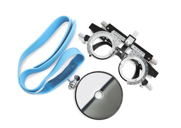 Trial frame and head mirror on white background, top view. Ophthalmologist tools