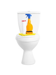 Toilet bowl and cleaning supplies on white background