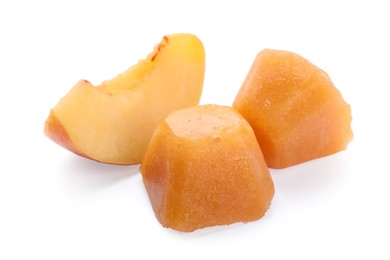 Photo of Frozen nectarine puree cubes and fruit on white background