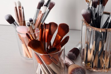 Photo of Set of professional brushes on table, closeup