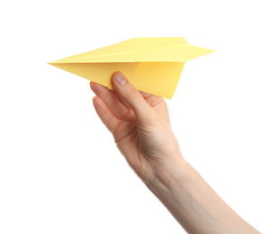 Woman holding yellow paper plane on white background, closeup