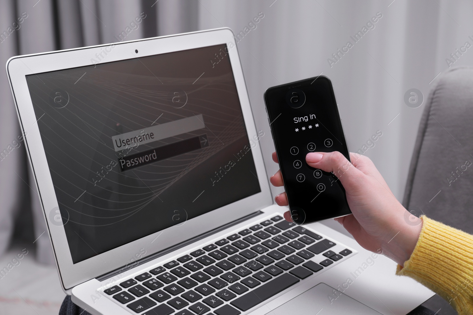 Photo of Woman unlocking smartphone with blocked screen near laptop indoors, closeup