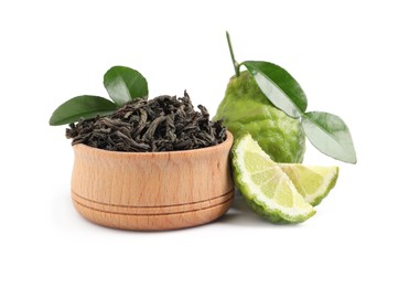 Photo of Dry bergamot tea leaves in wooden bowl and fresh fruits on white background