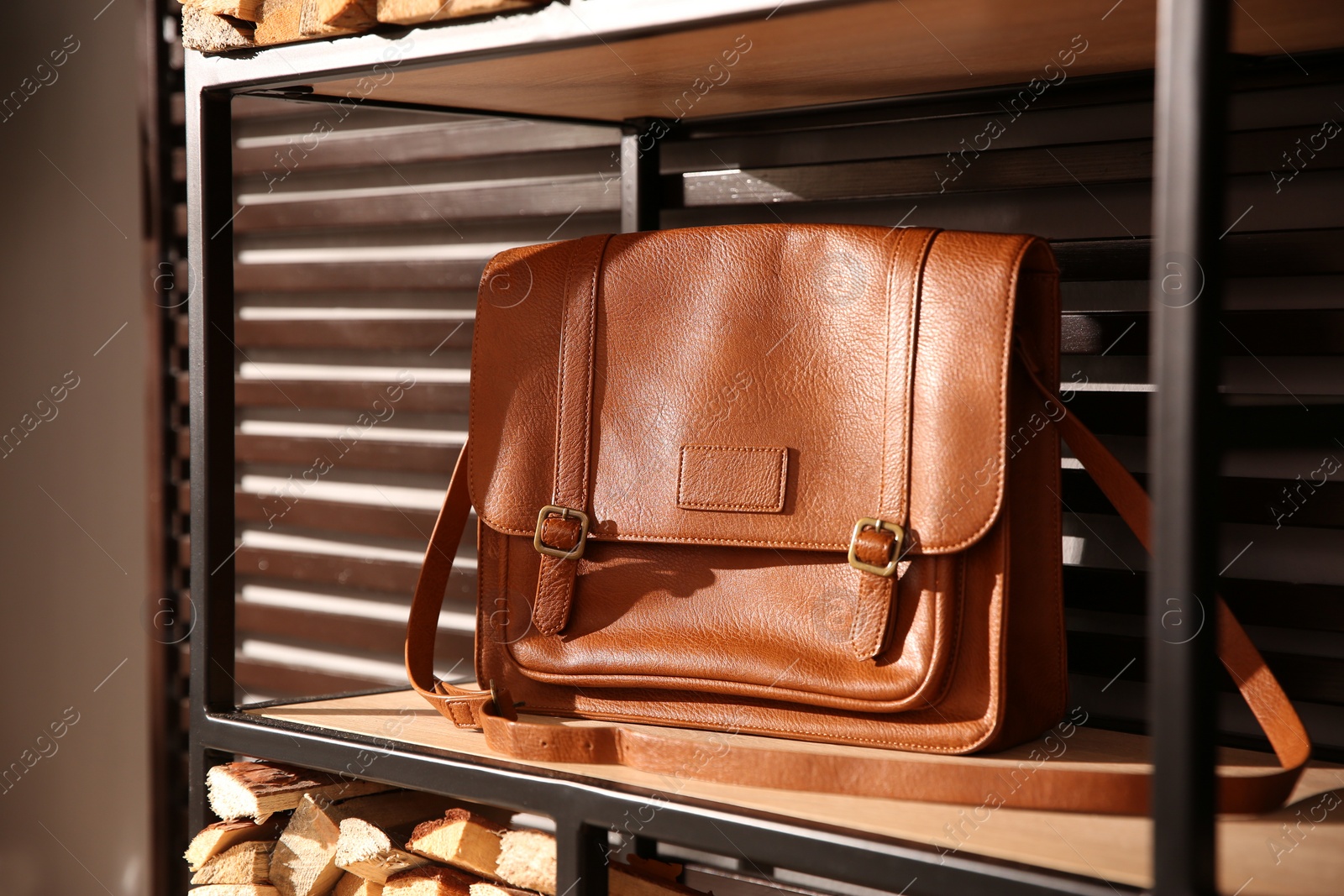 Photo of Stylish woman's bag on shelf in boutique