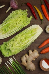 Flat lay composition with fresh Chinese cabbages and ingredients on wooden table