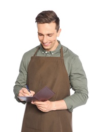 Photo of Handsome waiter in apron taking order on white background