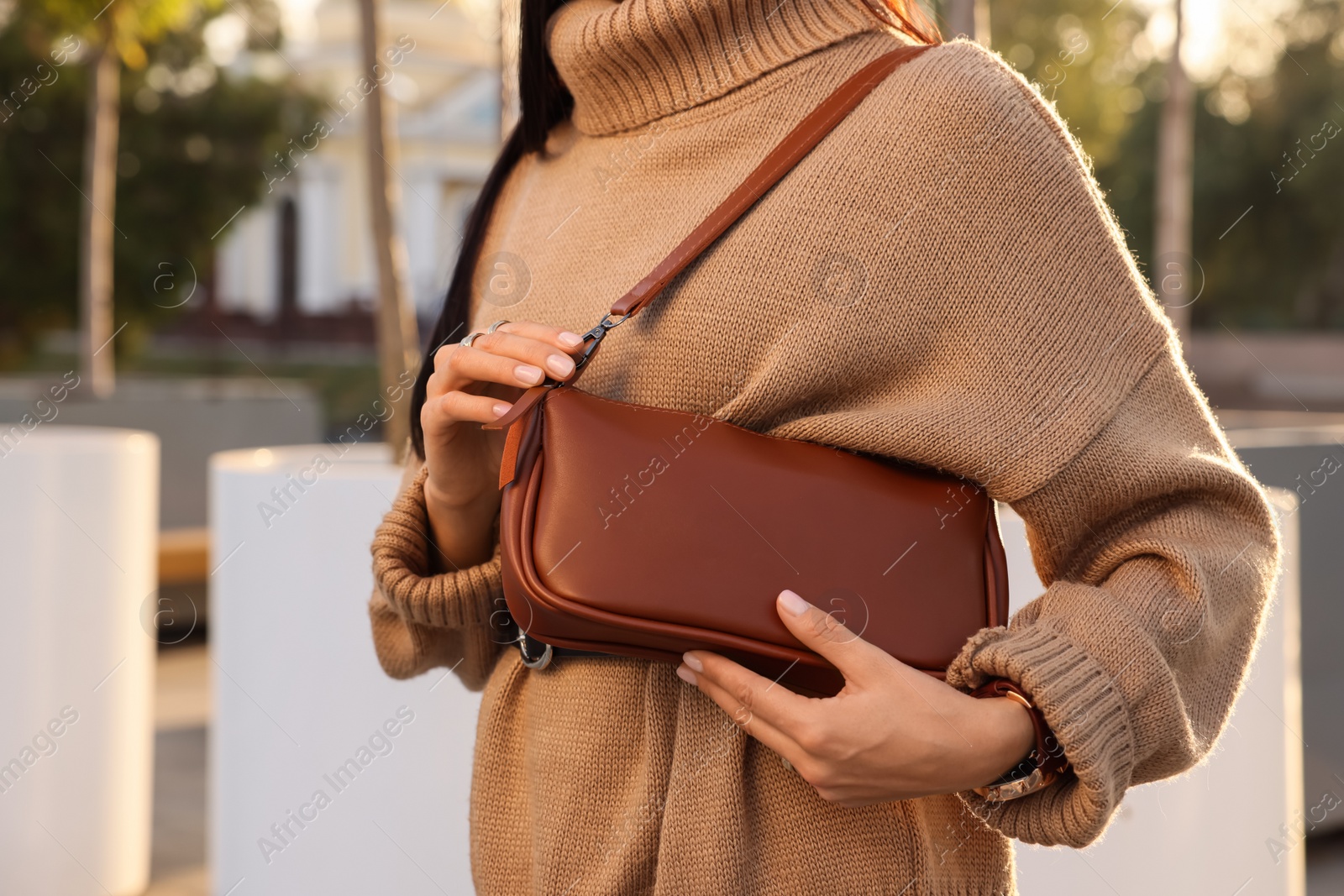 Photo of Fashionable woman with stylish bag on city street, closeup