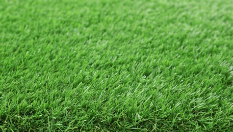 Photo of Artificial grass carpet as background, closeup. Exterior element