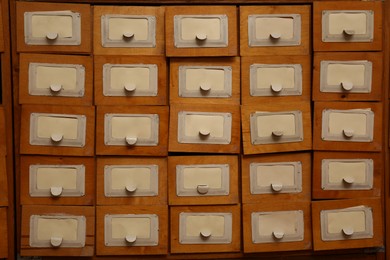 Photo of Library card catalog drawers as background, closeup