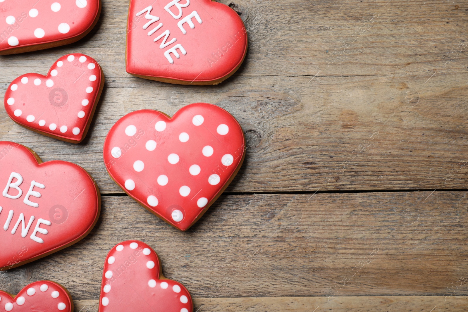 Photo of Heart shaped cookies on wooden table, flat lay with space for text. Valentine's day treat