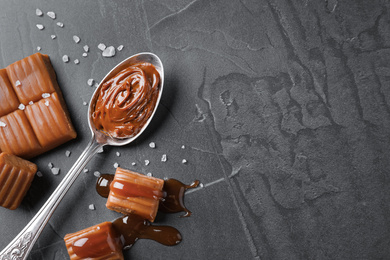 Photo of Salted caramel on grey table, flat lay. Space for text