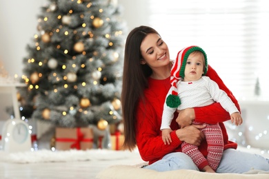 Photo of Mother and her cute baby at home. Christmas celebration