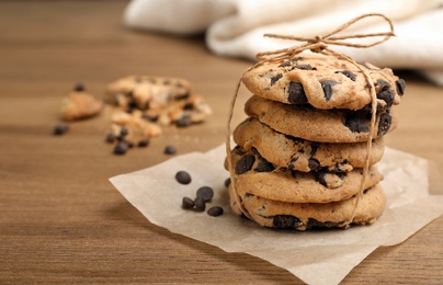 Photo of Stack of cookies with chocolate chips on wooden table