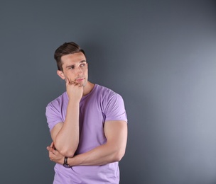 Handsome young man on color background