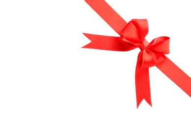 Red ribbon with bow on white background, top view