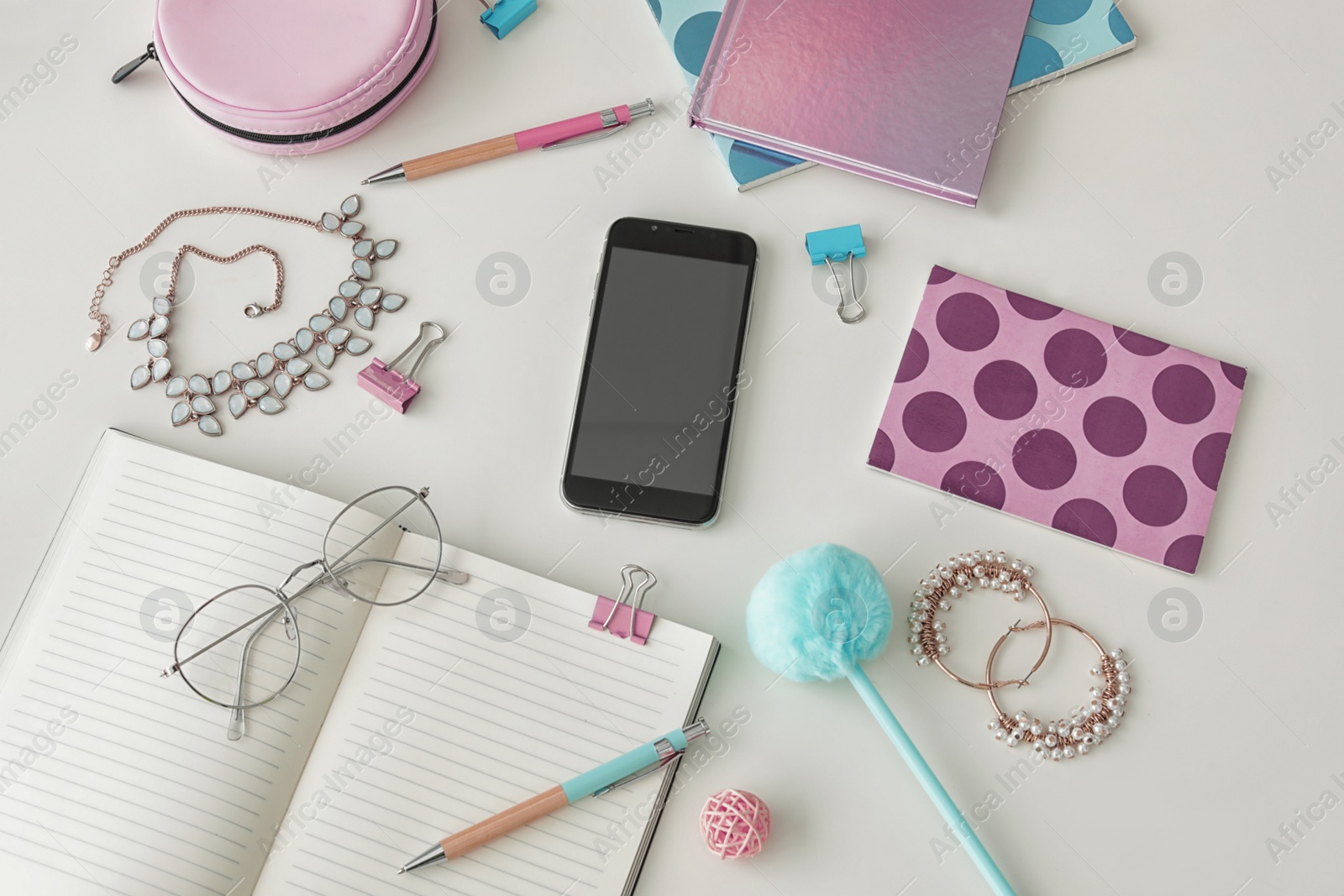 Photo of Flat lay composition with smartphone, notebook and accessories on light background, space for design. Blogger's workplace