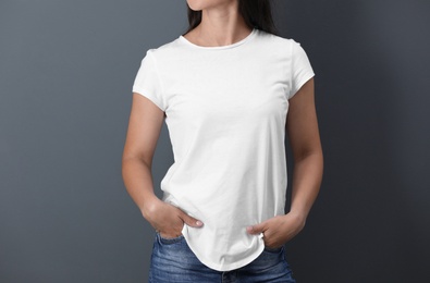 Photo of Young woman in white t-shirt on color background. Mockup for design