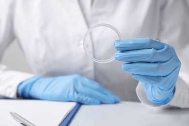 Photo of Doctor holding diaphragm vaginal contraceptive ring at table, closeup