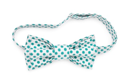 Stylish bow tie with green polka dot pattern on white background, top view