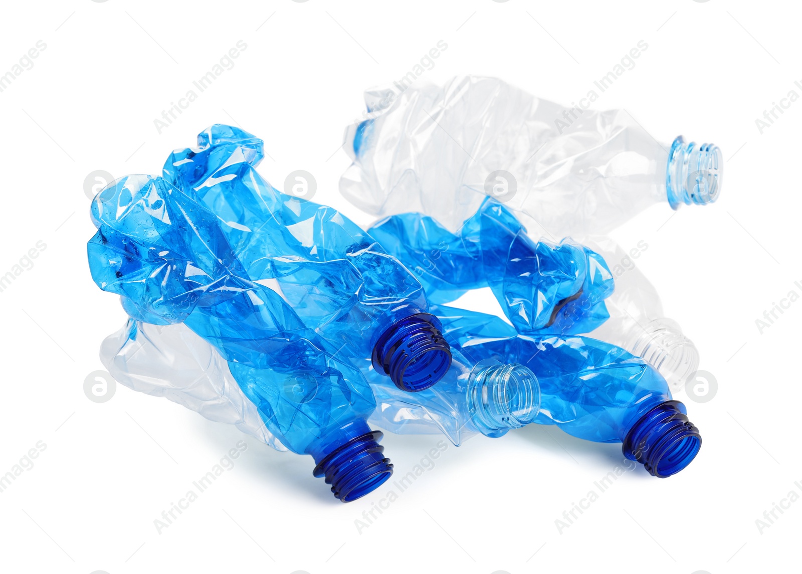 Photo of Crumpled disposable plastic bottles on white background