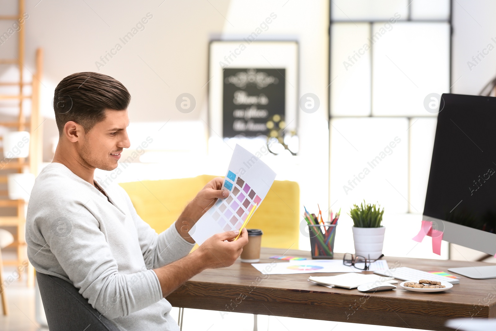 Photo of Male designer working at desk in office