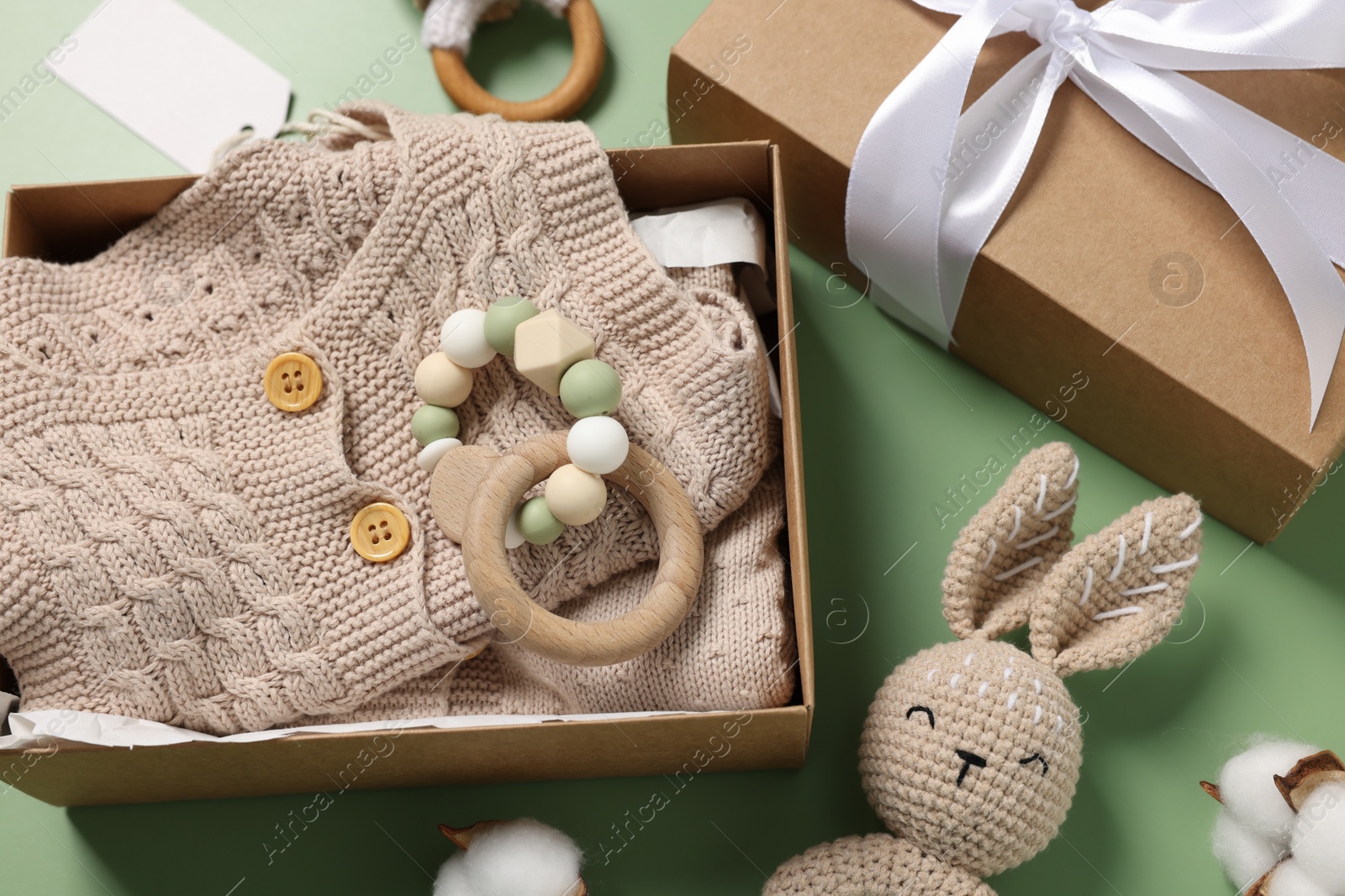 Photo of Flat lay composition with different baby accessories on green background