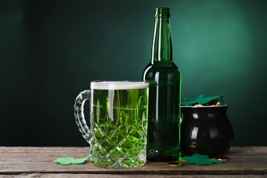 St. Patrick's day party. Green beer, leprechaun pot of gold and decorative clover leaves on wooden table