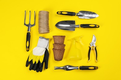 Photo of Flat lay composition with gardening tools on yellow background