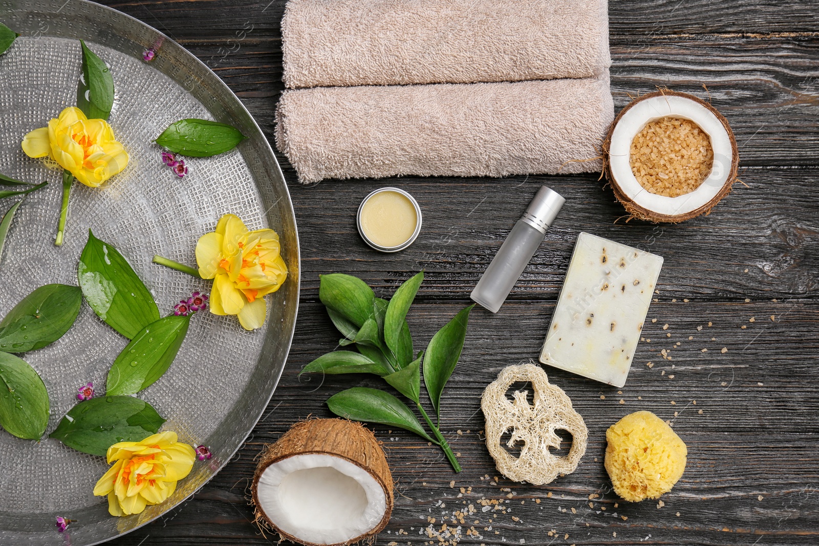 Photo of Composition with spa accessories and flowers on wooden background