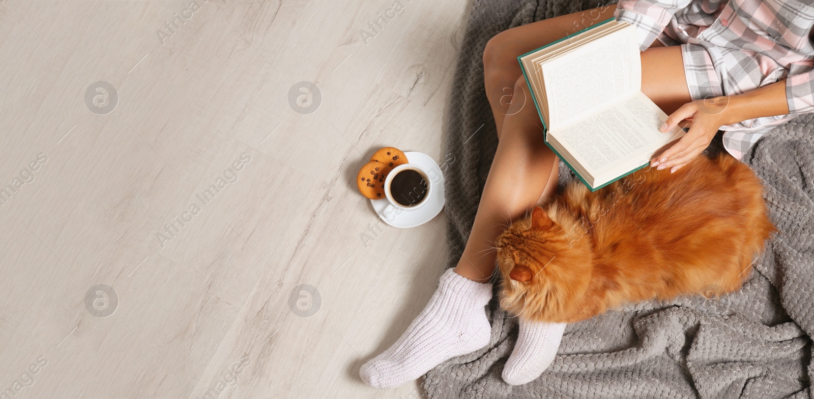 Image of Top view of young woman with her cute pet on floor, space for text. Banner design