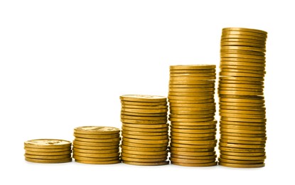 Photo of Many stacks of coins on white background
