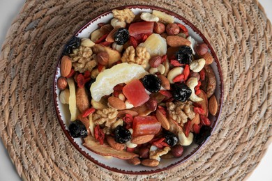 Bowl with mixed dried fruits and nuts on white table, top view