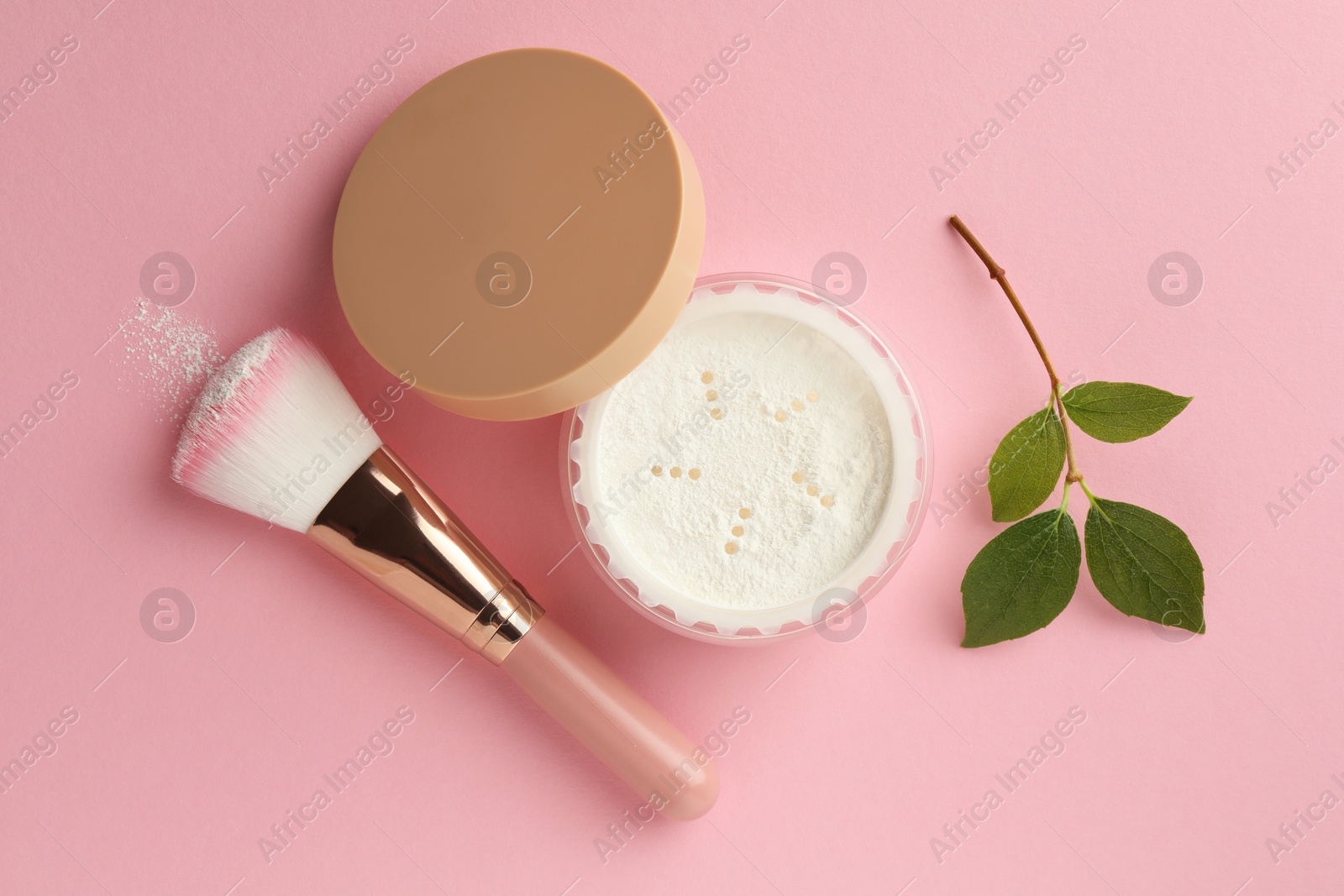 Photo of Rice loose face powder, makeup brush and branch on pink background, flat lay