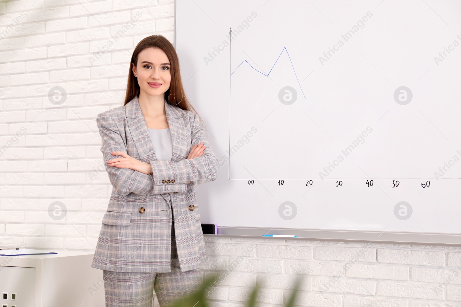 Photo of Professional business trainer near whiteboard in office