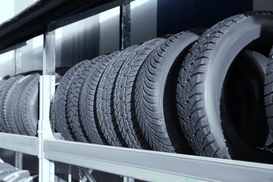 Photo of Tires on rack in car service workshop