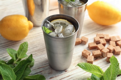 Photo of Composition with delicious mint julep cocktail on table