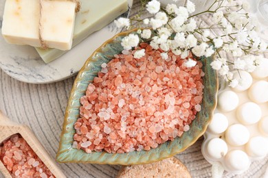 Photo of Sea salt, soap bars and dry shampoo on mat, flat lay