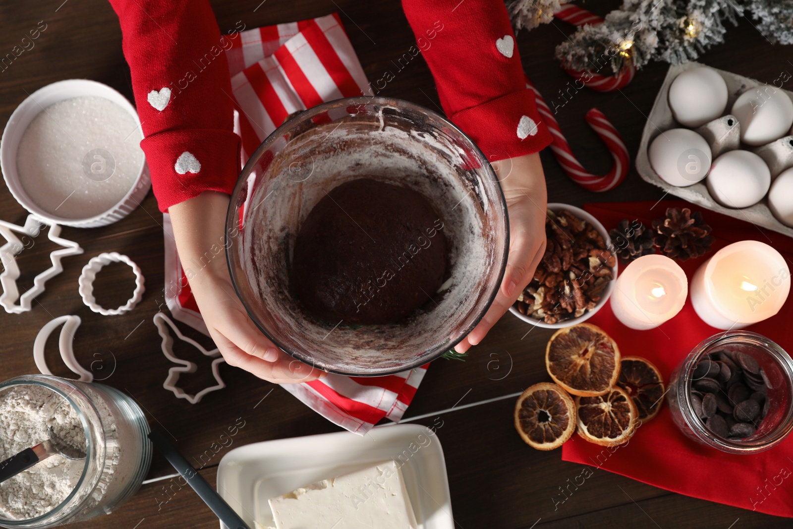 Photo of Little child making Christmas cookies at wooden table, top view