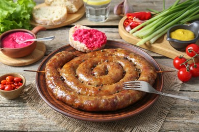 Tasty homemade sausages served on wooden table