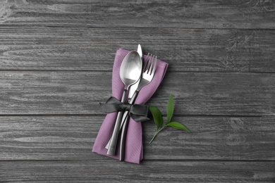 Cutlery set for festive table on dark wooden background, top view