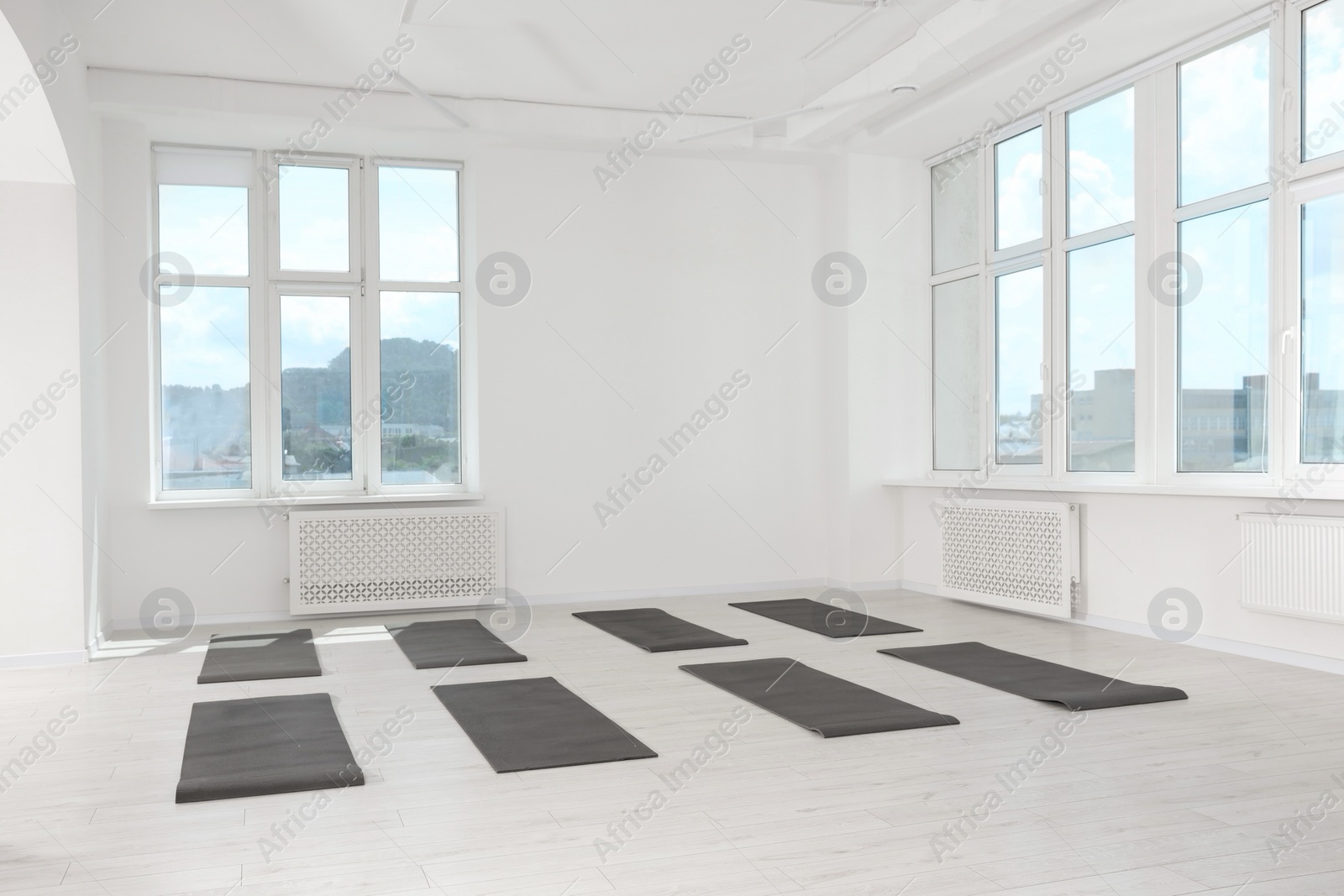 Photo of Spacious yoga studio with exercise mats and big windows