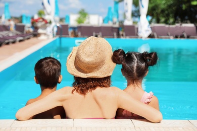 Photo of Woman with children in swimming pool at resort