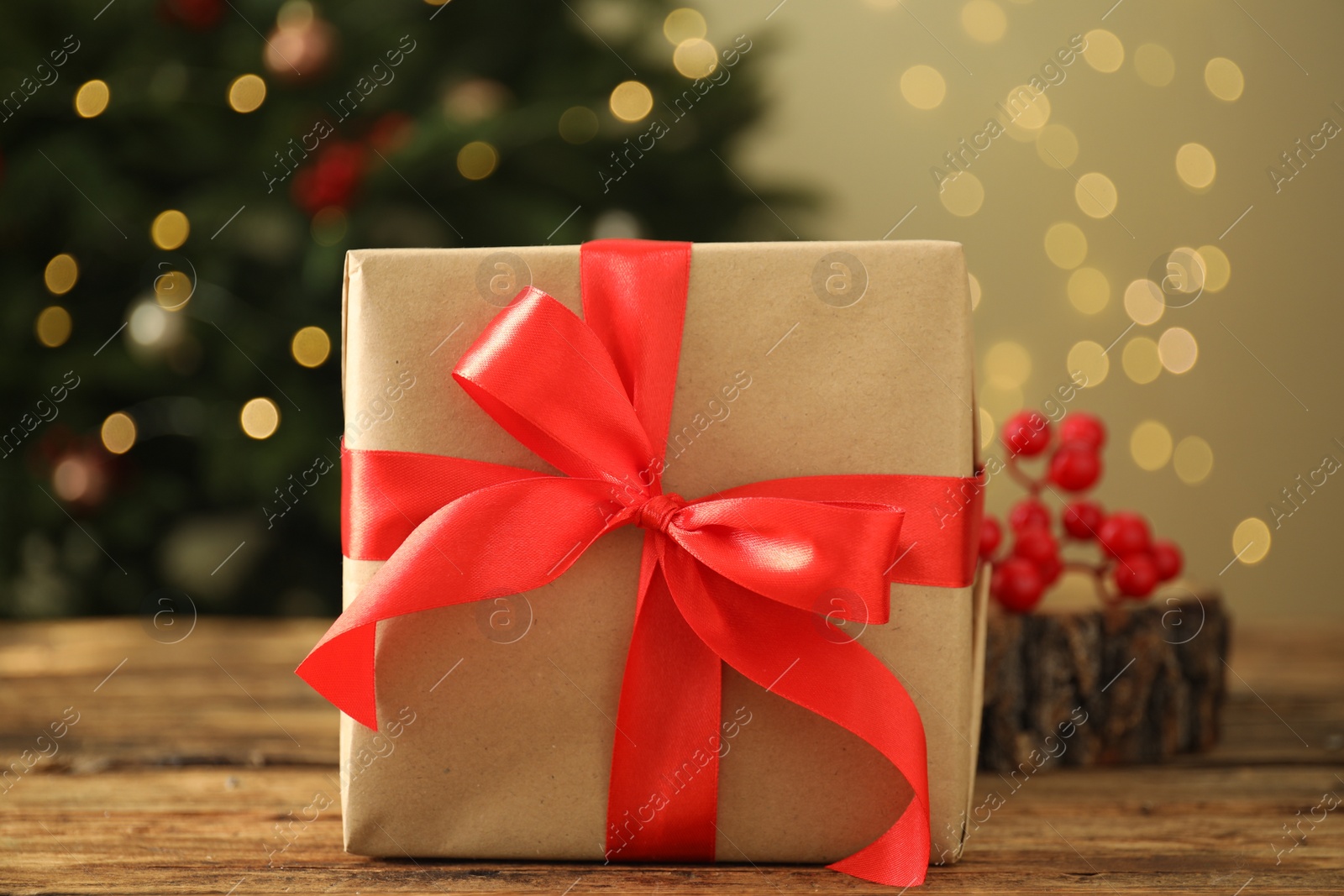 Photo of Beautiful gift box on wooden table, closeup. Christmas celebration